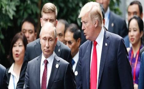 US President Donald Trump (R) and Russia's President Vladimir Putin talk during the family photo session at the APEC Summit in Danang, Vietnam Saturday, Nov. 11, 2017. AP photo