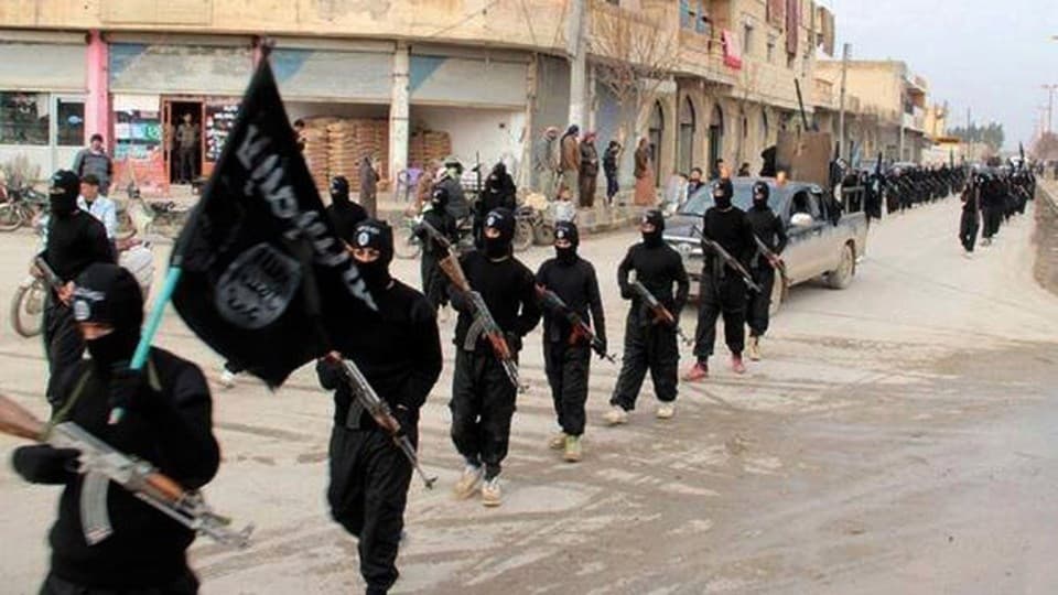 ISIS marches through Mosul. Photo: AP