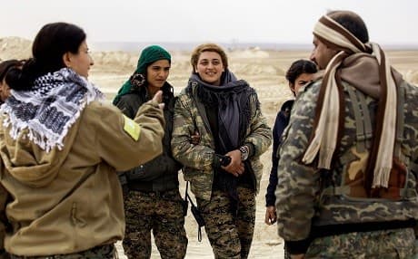 Female Arab fighters among the Syrian Democratic Forces, made up of US-backed Kurdish and Arab fighters, stand together near the village of al-Torshan, 20 km on the outskirts of Raqa last Monday. Photo: AFP/Delil Souleiman.