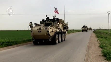A US flag flies on a convoy of vehicles including those with YPG flags. Video: Rudaw
