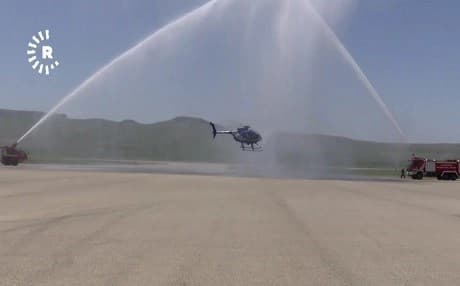 A helicopter flies through a shower of water in a ceremony on Wednesday. Photo: Rudaw TV