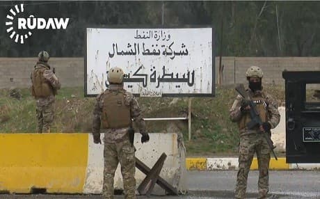 Members of the security forces of the Kurdish Patriotic Union of Kurdistan guard the main gate of the Iraqi North Oil Company in March. Photo: Rudaw video