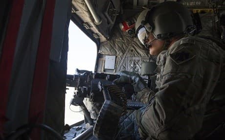 US Army Sgt. Denis Fairleigh looks out over a machine gun on a CH-47 Chinook near Mosul last week. Photo: Cpl. Rachel Diehm/US Army