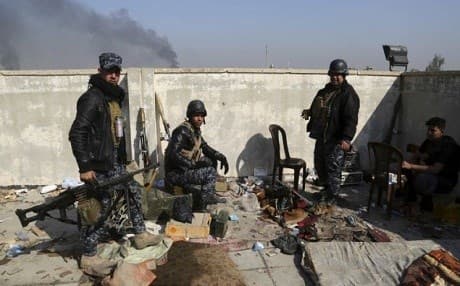 Soldiers take combat positions as Iraqi security forces advance during fighting against ISIS militants in western Mosul, Iraq. Photo: AP