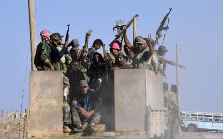 Syrian government forces celebrate in the eastern Syrian city of Deir Ezzor on September 11. Photo: George Ourfalian | AFP