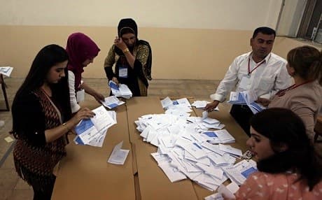 Referendum officials count ballots at a voting station in Erbil on Mondy. Photo: AP