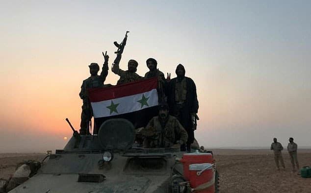 Syrian forces in a village near al-Boukamal on November 10. Photo: AFP