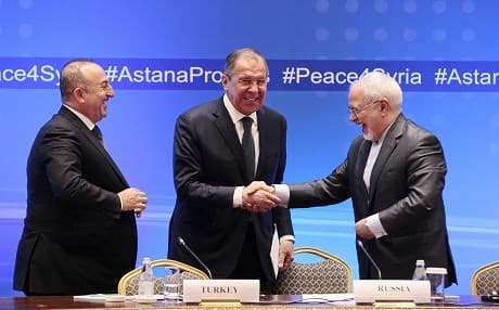 Russian Foreign Minister Sergei Lavrov (center) shakes hands with Iranian Foreign Minister Mohammad Javad Zarif (R) and Turkish Foreign Minister Mevlut Cavusoglu following their talks on Syria in Astana on March 16, 2018. Photo: Alexey Filippov | AFP