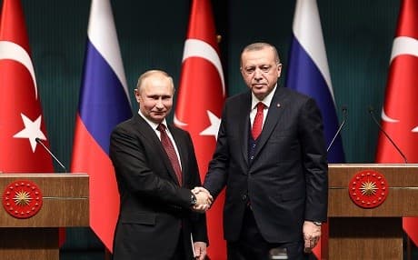 Russian President Vladimir Putin (left) and Turkish President Recep Tayyip Erdogan (right) shake hands after a press conference at the Presidential Complex in Ankara on April 3, 2018. Iranian President Hassan Rouhani (not pictured) arrived later in the day. Photo: Adem Altan | AFP