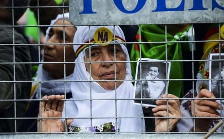 A woman holds a photo of Selahattin Demirtas during a rally in Diyarbakir in April 2017. Photo: Ilyas Akengin/AFP
