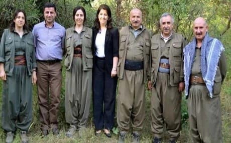 Selahattin Demirtas (second left) and current HDP co-chair Pervin Buldan (center) pose with PKK fighters at a camp in Qandil during the peace negotiation process. Photo: AA