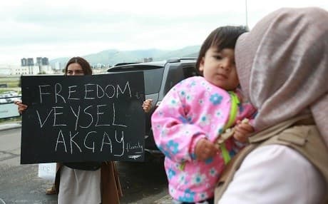 Students hold up banners in support of their teacher, Turkish school director Veysel Akcay, at the airport in Ulaanbaatar on July 27, 2018. Photo: Byambasuren Byamba-Ochir/AFP