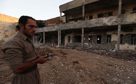 An Iranian Kurdish Peshmerga of the Iranian Kurdistan Democratic Party (PDKI) checks the damage after an Iranian rocket attack on its headquarters, September 8, 2018. Photo: Safin Hamed / AFP