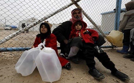 A displaced Syrian man and children wait to fill up water containers at the Internally Displaced Persons (IDP) camp of al-Hol in al-Hasakah governorate in northeastern Syria on December 17, 2018. Photo: Delil Souleiman/AFP