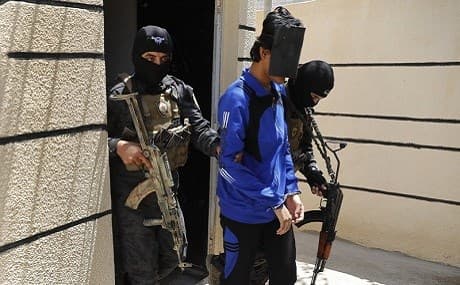 Kurdish soldiers from the Anti-Terrorism Units with a blindfolded Indonesian man suspected of Islamic State membership at a security center in Kobani, Syria, July 21, 2017. File photo: Hussein Malla / AP