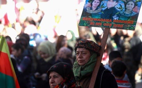 A Syrian kurdish woman holds a placard during a demonstration in Qamishli on January 20, 2019, marking the first anniversary of the Turkish takeover of Afrin. Photo: Delil Souleiman/AFP