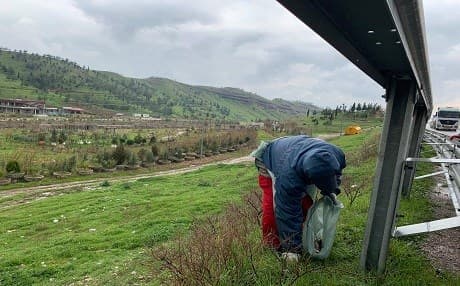 Mohammed Sumon from Bangladesh pick up trash in Dilopa, Erbil province in preparation for Newroz festivities. Photo: Zhelwan Z. Wali/Rudaw