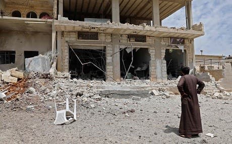 A man stares at a building damaged during reported shelling by government and allied forces, in the town of Hbeit in the southern countryside of the rebel-held Idlib province on May 3,2019. Photo: Omar Haj Kadour/AFP