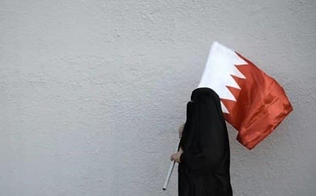 A woman holds the flag of Bahrain. File photo: Mohammed al-Shaikh / AFP