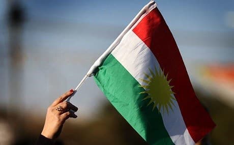 A woman waves the flag of Kurdistan in Erbil. File photo: Safin Hamed / AFP