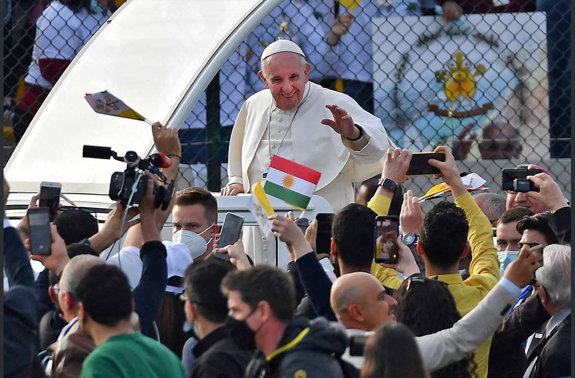 Pope Francis blesses people as he arrives in the popemobile vehicle at the Franso Hariri Stadium in Erbil, on March 7, 2021, in the Kurdistan Region. Photo: Vincenzo Pinto / AFP