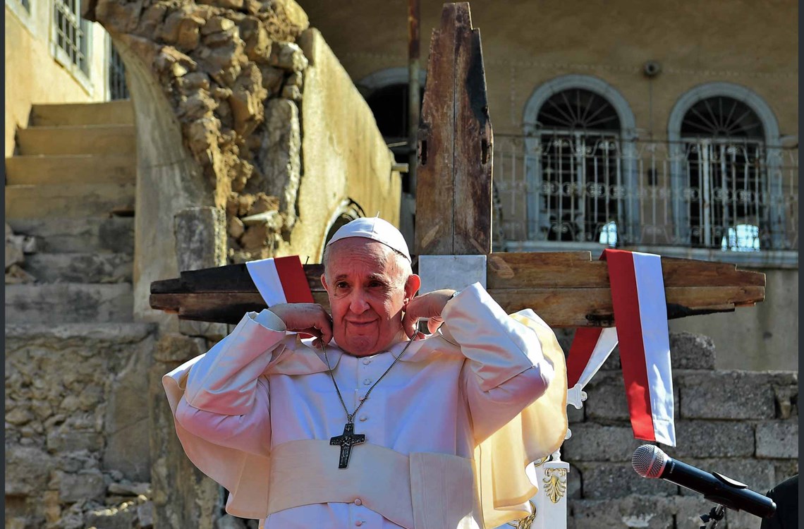 A handout picture released by the Vatican media office, shows Pope Francis, adjusting his cape during at a square near the ruins of the Syriac Catholic Church of the Immaculate Conception (al-Tahira-l-Kubra), in the old city of Iraq's northern Mosul on March 7, 2021. Photo: VATICAN MEDIA / AFP