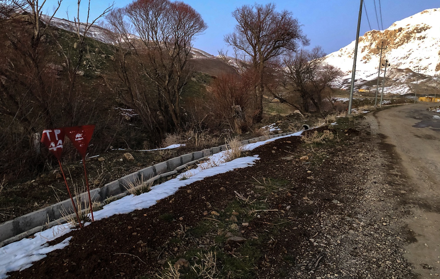 Small signs mark landmines laid during the 1980s Iran-Iraq war at the roadside in Halgurd-Sakran National Park on February 23, 2021. Photo: Hannah Lynch / Rudaw