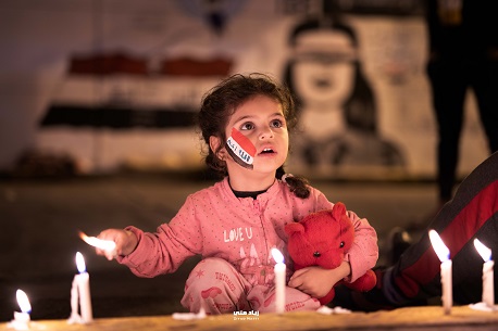 A young girl joins commemorations in Tahrir Square. Photo: Ziyad Matti