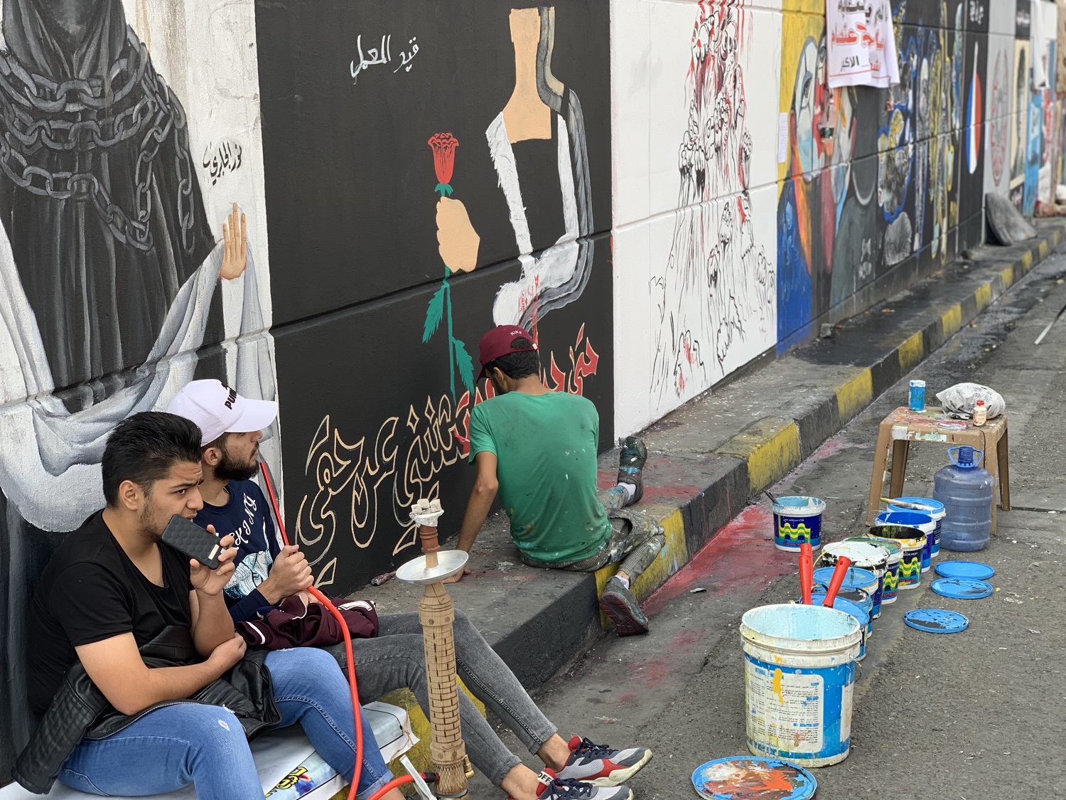 An artist painting the wall of Tahrir Square tunnel, Baghdad on December 3, 2019. Photo by: Lawk Ghafuri