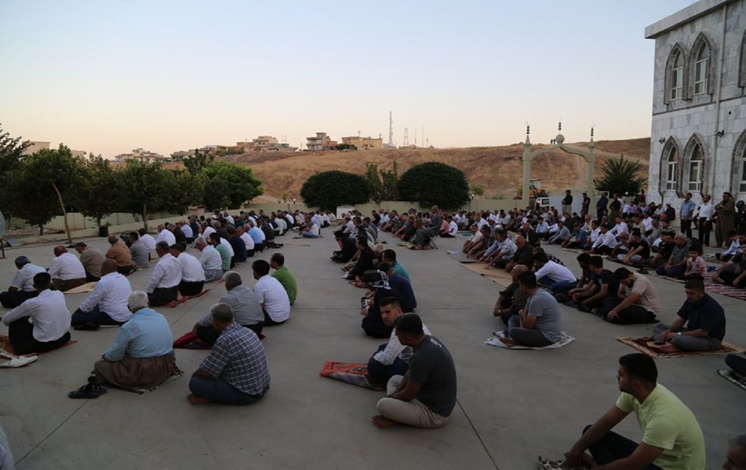 Worshippers sit outside the Barkew mosque in Sulaimani on Friday. Photo submitted by Dana Gharib
