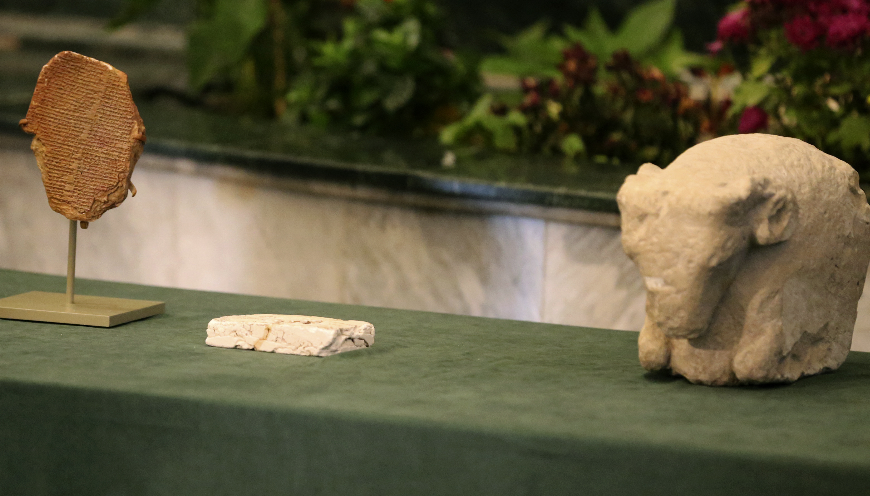A Sumerian ram's head (R) and a Sumerian tablet (L) can be seen displayed in the Iraqi Ministry of Foreign Affairs in Baghdad on December 7, 2021 after its repatriation. Photo: AFP