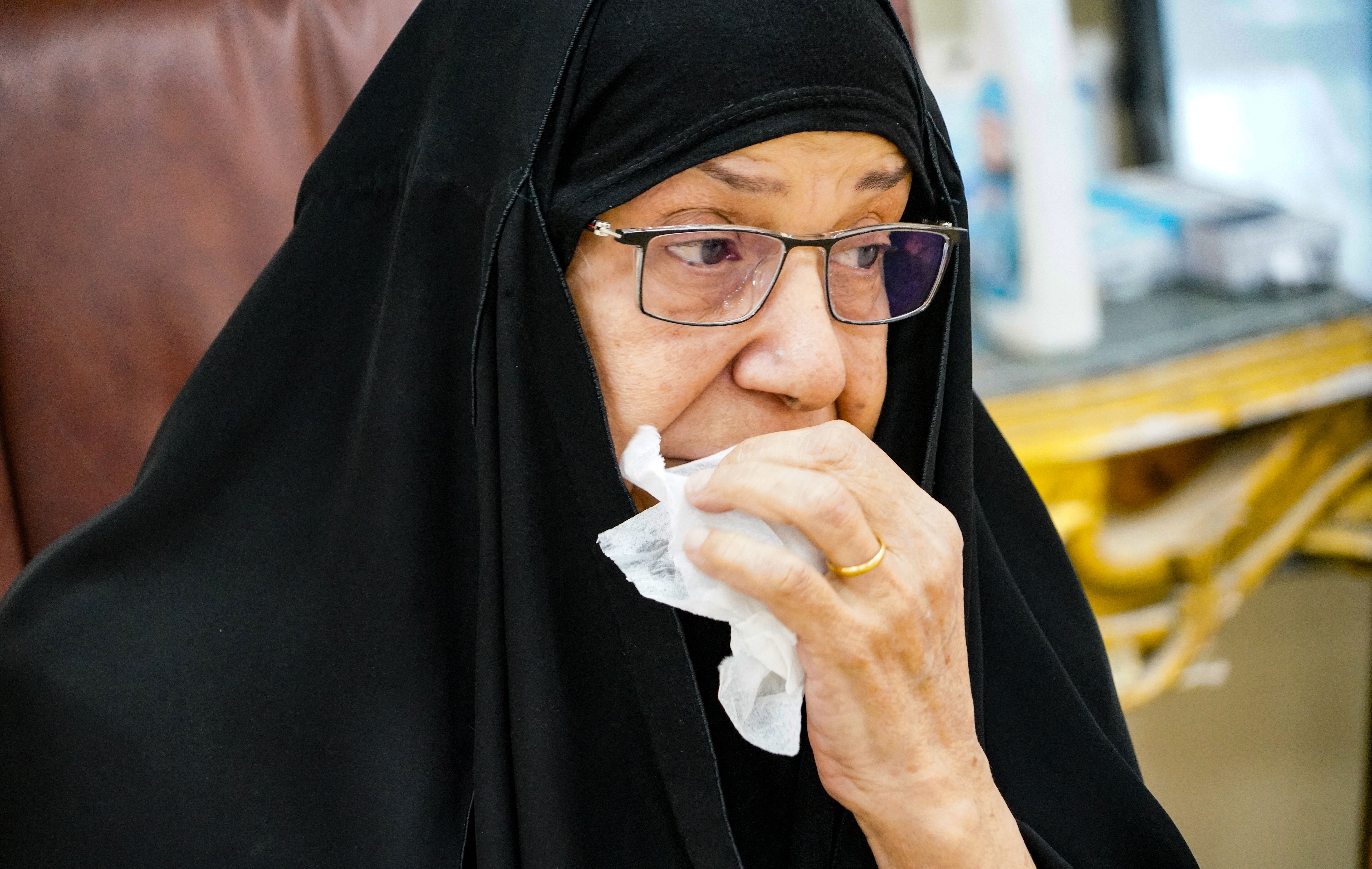 Intissar Mohammed, the sister of a missing person, reacts as she waits to provide a drop of her blood as a sample, after Iraqi authorities suspected her brother's remains could be found in a mass grave site, in the central city of Najaf, on January 21, 2022. Photo: Qassem al-Kaabi/AFP