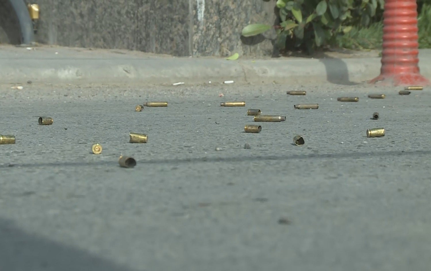 Spent bullet casings litter the ground in front of a busy apartment complex in Erbil on May 1, 2021. Photo: Rudaw