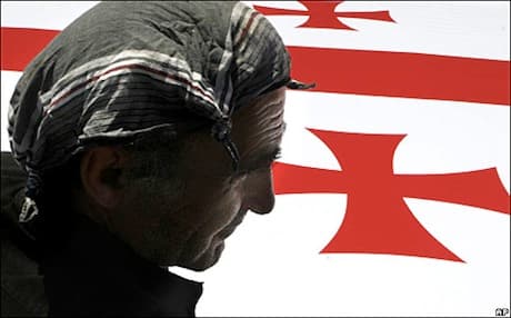 In Tbilisi, Georgia, a worker installs a flag in preparation for independence day celebrations, 2008. Photo: AP