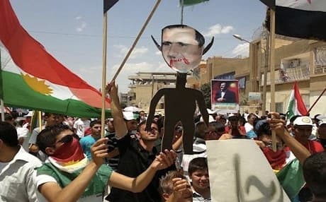 Anti-Syrian regime Kurdish protesters holding an effigy of Syrian President Bashar Assad as they wave their Kurdish flag during a demonstration called the "Friday of Russia is the enemy of Syrian people," at the northeastern town of Amuda, June 2012. Photo: AP