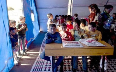 Syrian Kurdish refugee children from the Kobani area attend classes in a makeshift school at a refugee camp in Suruc, near the Turkey-Syria border. Photo: AP
