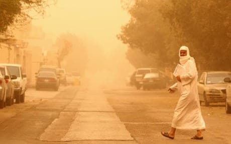 A man crosses a street in Riyadh during a major sandstorm. Photo: AFP