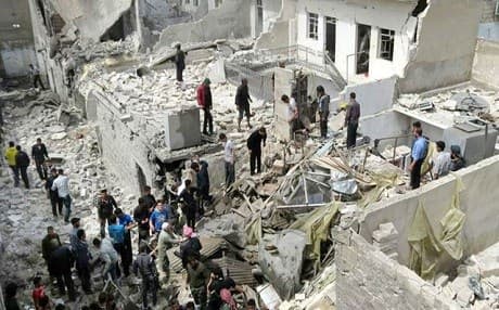 People gathered in the ruins of an attack on a civilian neighborhood in Aleppo. Photo: AP