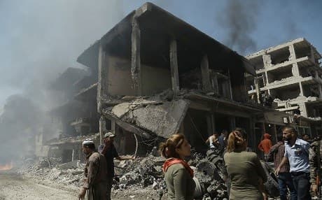 People gather at the site of a massive double bombing in Qamishli, Rojava, northern Syria on Wednesday. Photo: Delil Souleiman/AFP