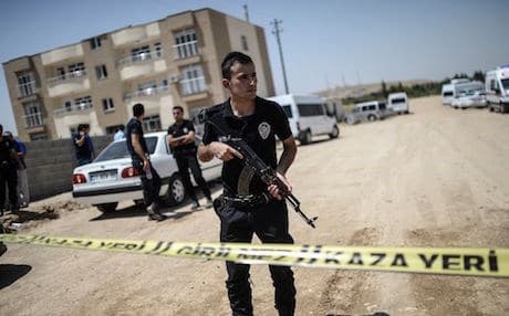 Turkish policemen stand guard near a building where two police officers were found shot dead at their home in July 2015 in the Turkish town of Ceylanpinar. AFP photo 