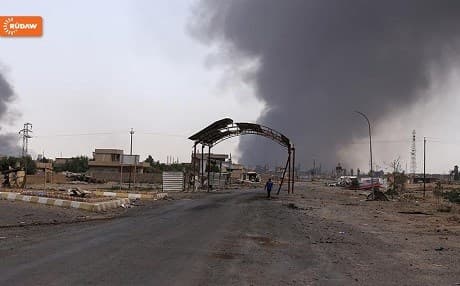 Smoke rising from a burning oil well in the town of Qayyara as set on fire by ISIS militants during battle with Iraqi troops. Photo Rudaw