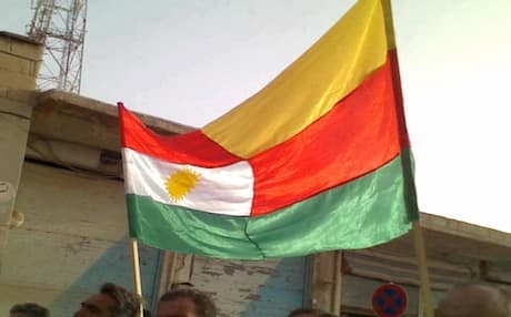 Kurdistan and PYD flags sown together and waved on the streets of Kobane on the day of its liberation from Syrian forces in July 2012. Photo: dimoqrati.info