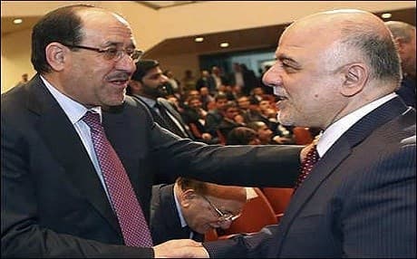 Nouri al-Maliki (left) shakes hands with his successor, Prime Minister Haider al-Abadi, in 2014. AP file photo. 