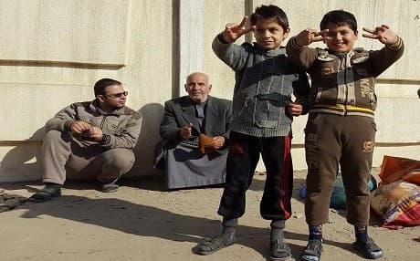 Two young boys waving the Victory sign in the al-Zuhur neighborhood of Mosul shortly after liberation from ISIS. Photo by Ayub Nuri