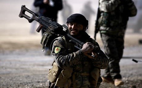 Fighters from the Syrian Democratic Forces gather near a village northeast of Raqqa on Friday. Photo: Delil Souleiman/AFP.