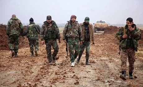 Pro-Syrian government forces walk in the northern province of Aleppo. Photo: AFP