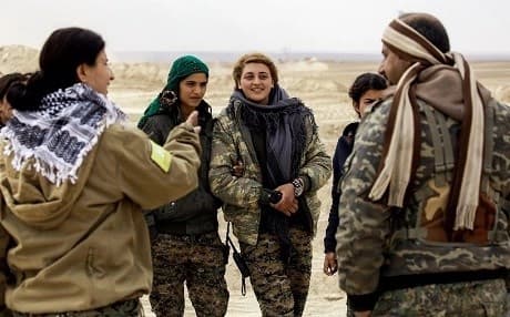 Cihan Sheikh Ahmad (L), spokesperson for the SDF’s Wrath of Euphrates campaign to isolate Raqqa, speaks with fellow SDF fighters on the outskirts of Raqqa on February 6. Photo: Delil Souleiman/AFP