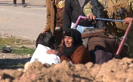 A family from a village nearby Mosul airport flee to Iraqi army lines. Photo: Rudaw video