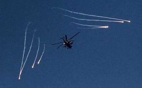 VIDEO: a helicopter seen carrying out strikes against ISIS positions in Mosul on Tuesday. 
