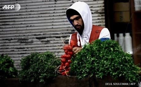 A vegetable-seller in Qamishli, Rojava, northern Syria. Photo: Delil Souleiman/AFP
